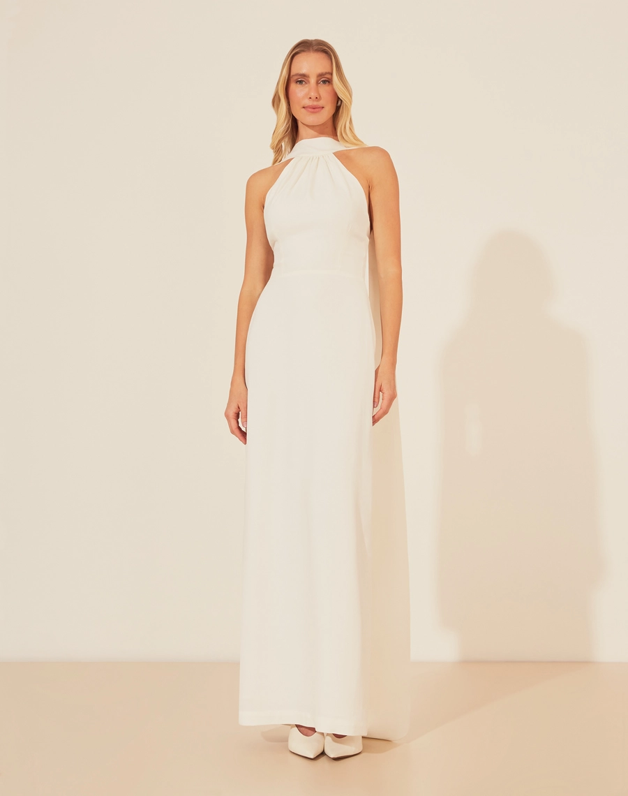 Vestido Longo Katerine 
com design minimalista e atemporal, o vestido longo Katerine é confeccionado em crepe patou, proporcionando um caimento fluído e elegante.<br/> O decote halter realça os ombros, enquanto as linhas retas da saia alongam a silhueta. Ideal para ocasiões formais, esse modelo exala sofisticação e é a escolha certa para quem busca um look discreto e impactante ao mesmo tempo.<br/>