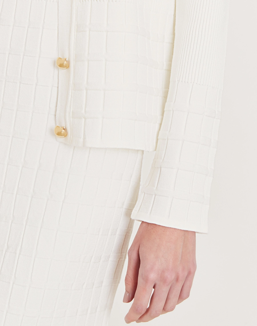 Cardigan Helena em tricot feminino com botões dourados, textura canelada e quadriculada. Elegância e conforto para dias frescos.